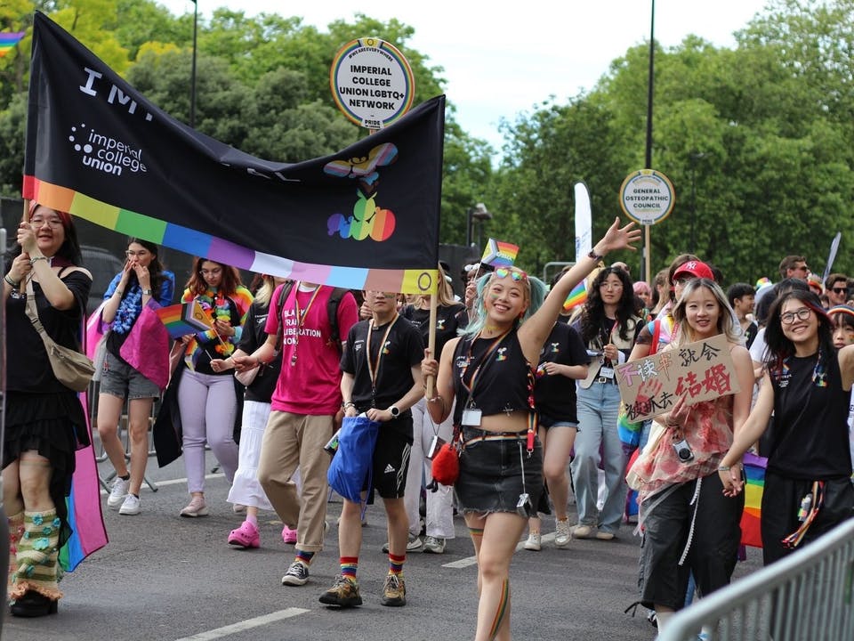 ICU LGBTQ+ students marching and smiling at Pride London