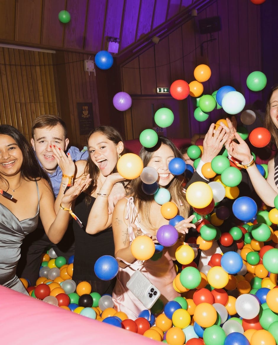 5 students in a ball pit